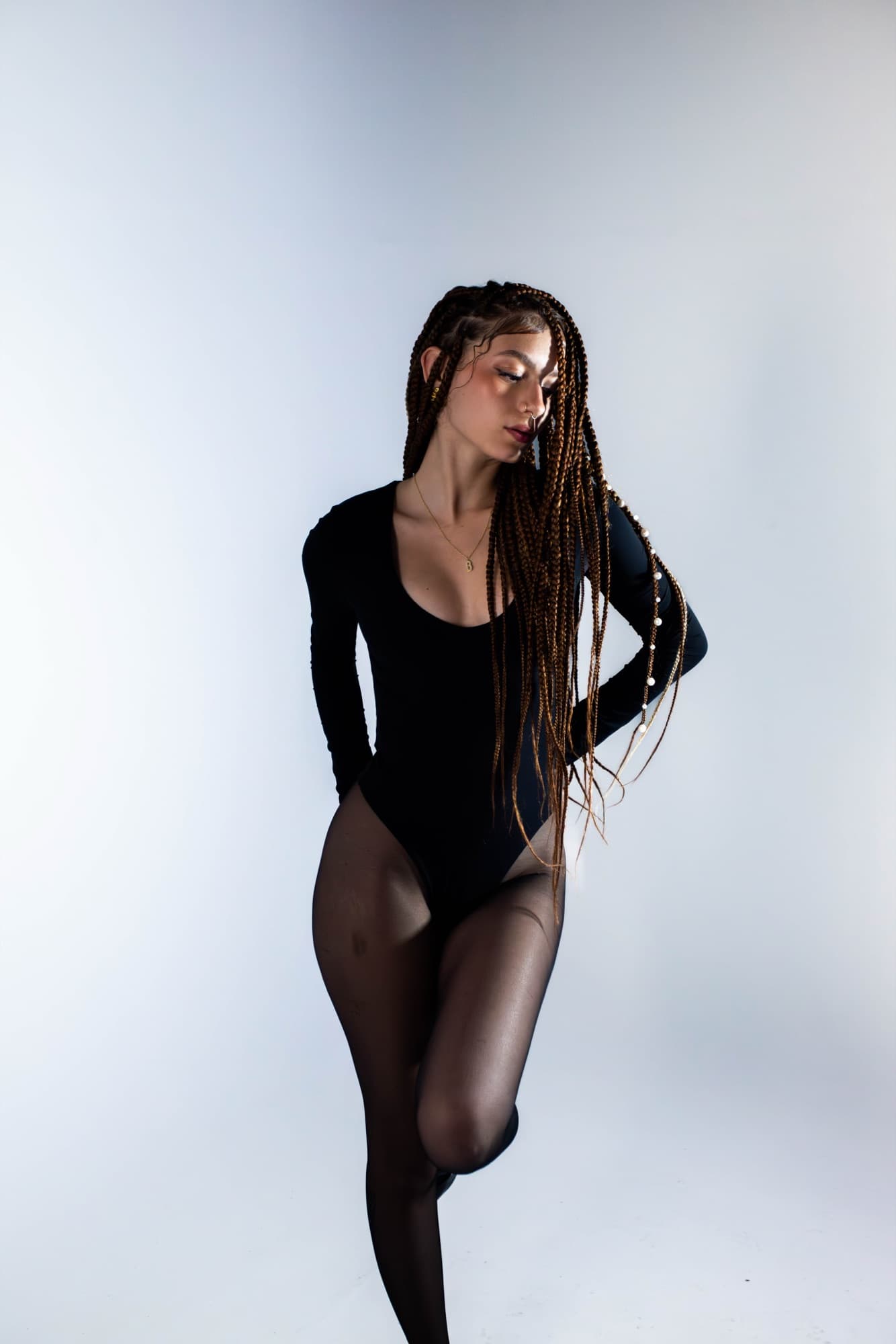 Full-length studio pose in a black bodysuit