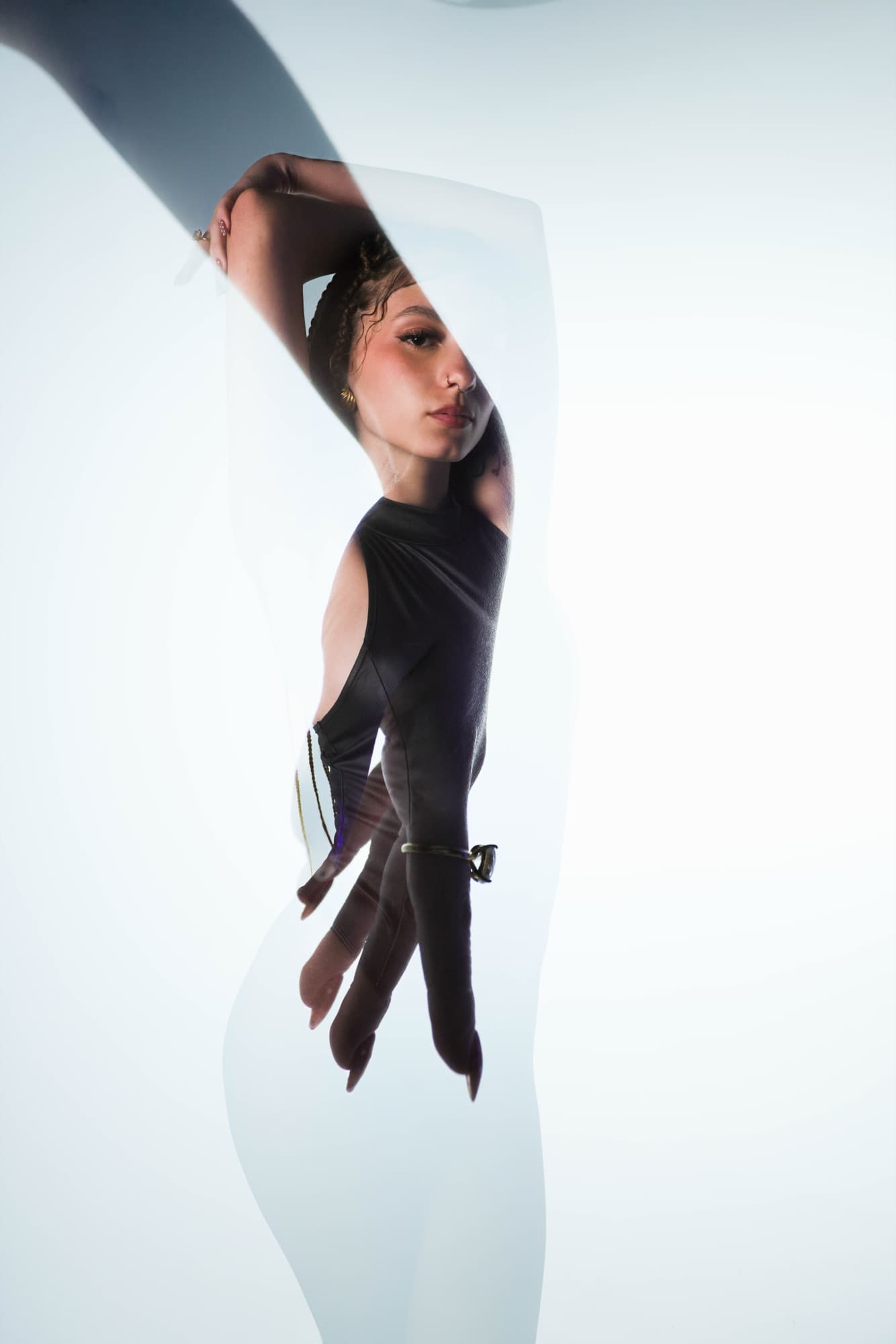 High-key double exposure of her profile and hand