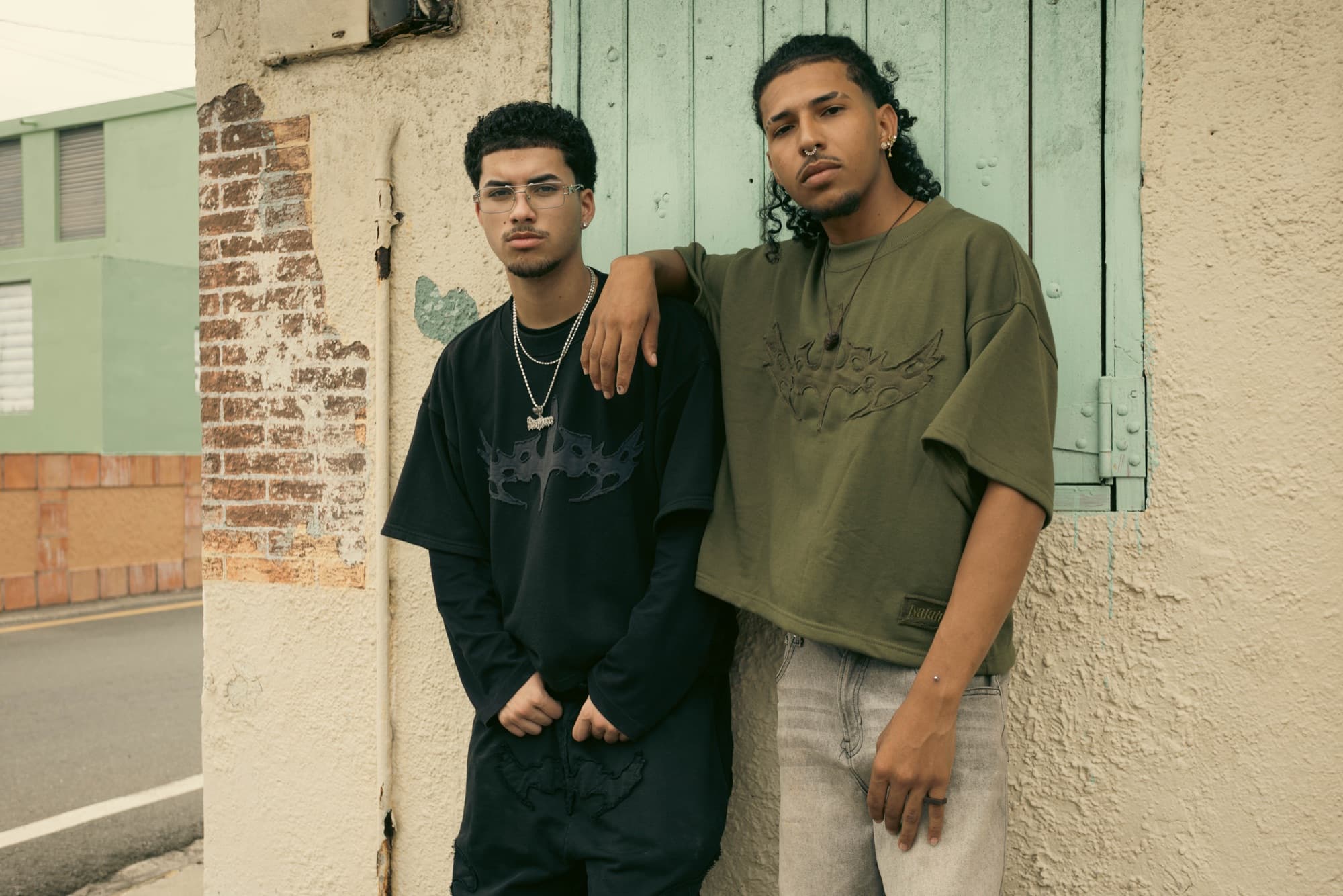 Two models framed by a weathered doorway