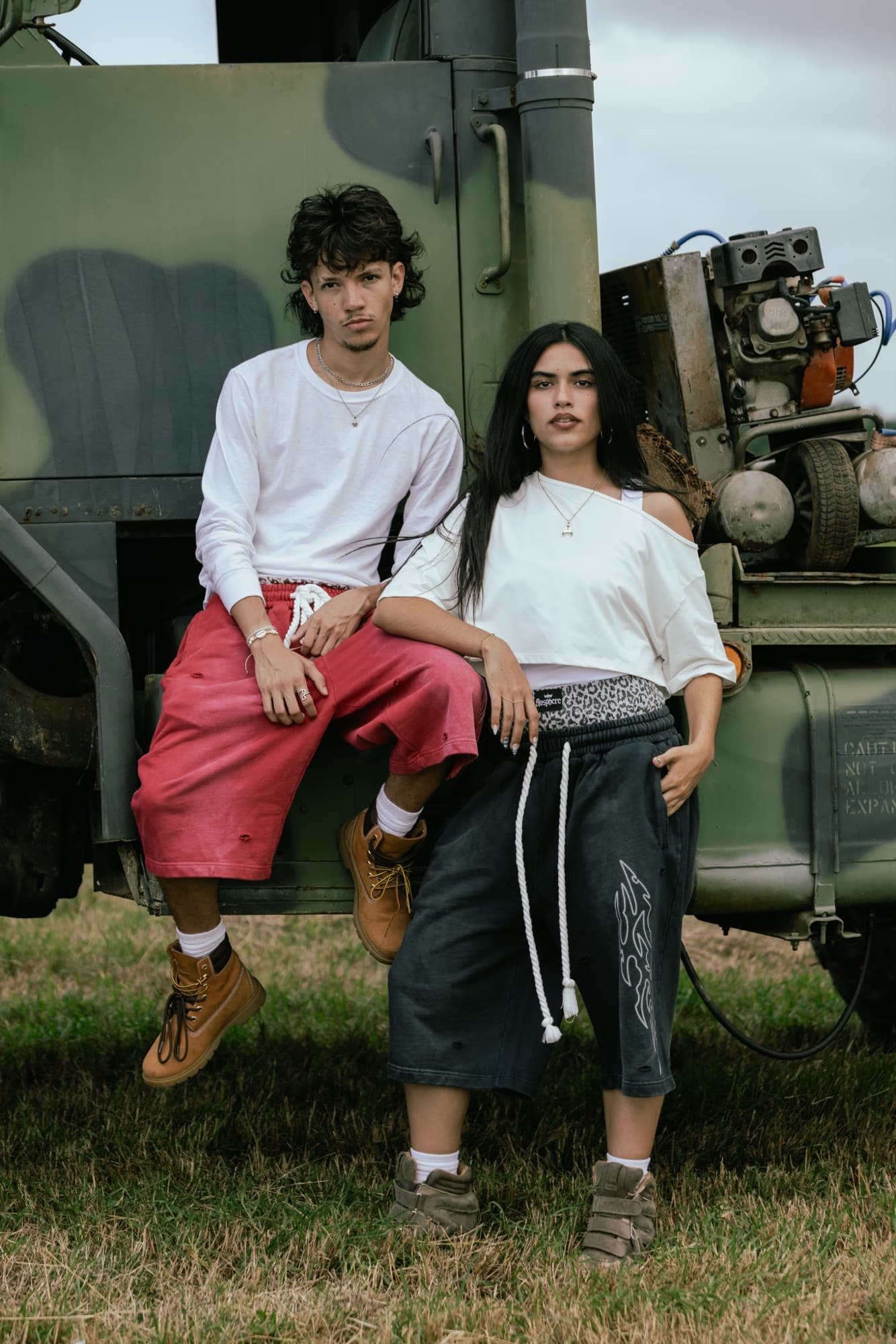 Three models posed on a vintage truck