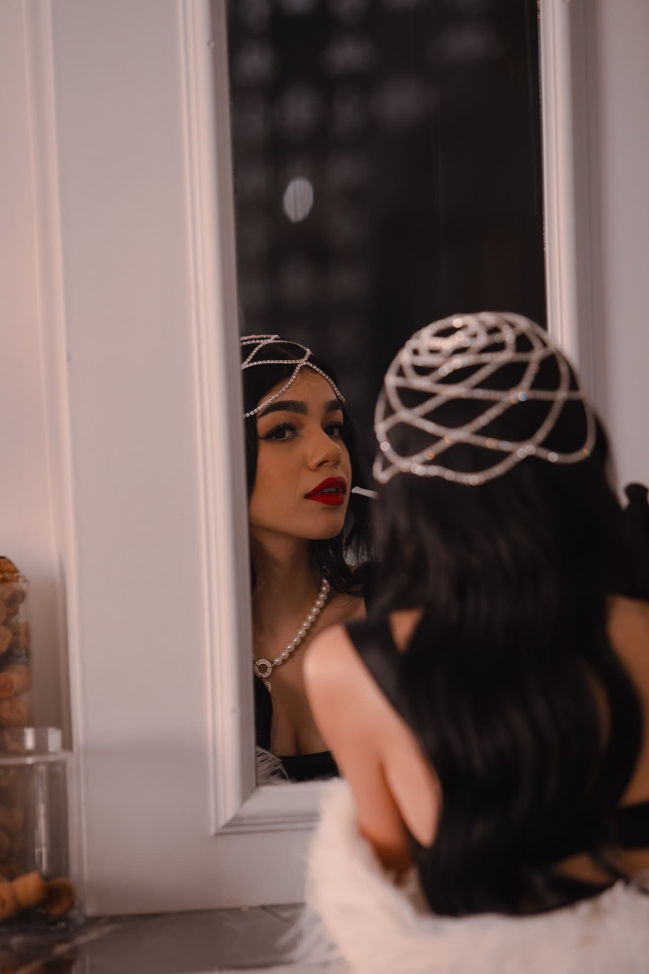 Two guests reflected in an ornate mirror