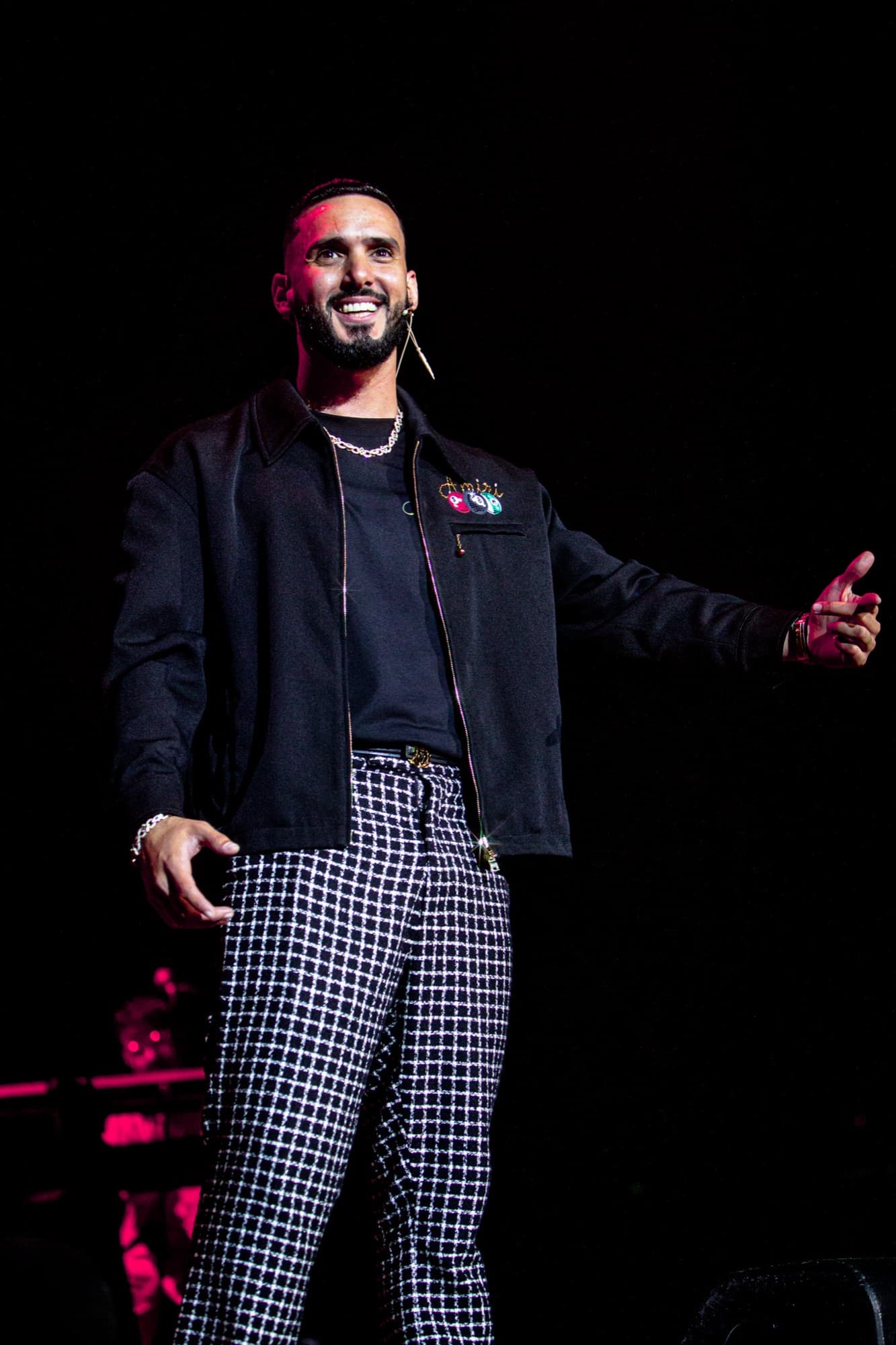 Detail of the black jacket and checkered trousers mid-set
