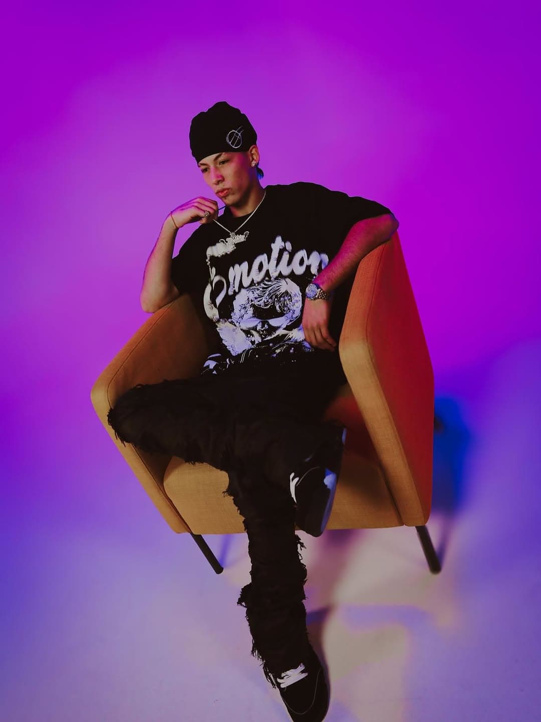 Urban artist against a neon purple studio backdrop